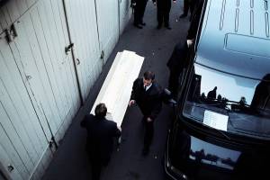 Undertaker at work with a coffin in Berlin