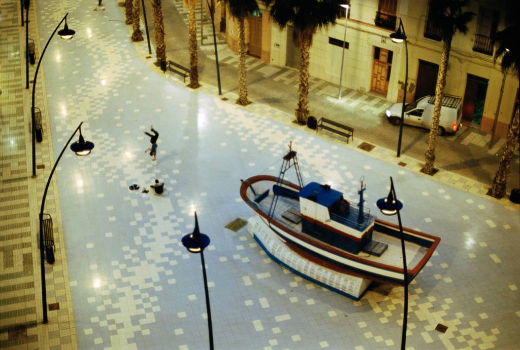 A fishing boat with a brake-dancer on a public square in Melilla